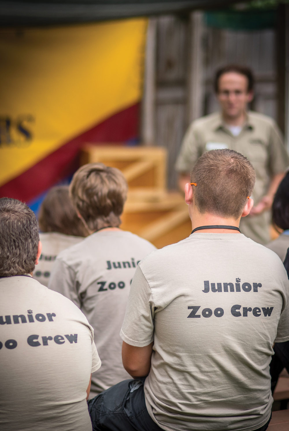 People wearing "Junior Zoo Crew" t-shirts gathered outdoors.