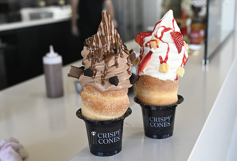 Close-up of chocolate and vanilla soft-serve ice cream in cinnamon-sugar pastry cones.