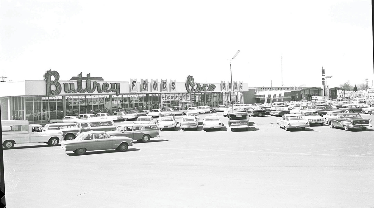 Vintage black-and-white photo of Buttrey Food and Osco Drug grand opening with a full parking lot.