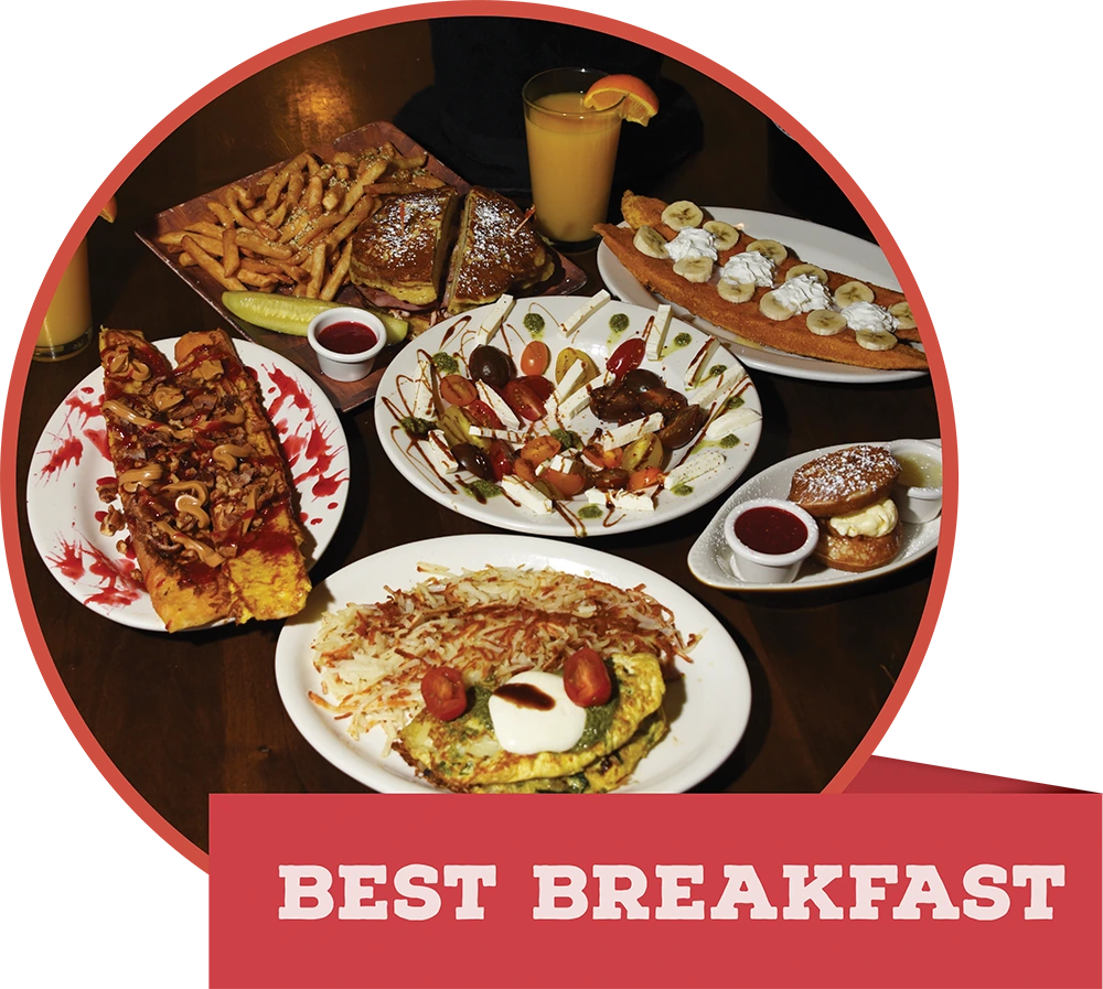 A large breakfast table spread featuring an omelet, hashbrowns, and French toast, with a banner reading "BEST BREAKFAST."